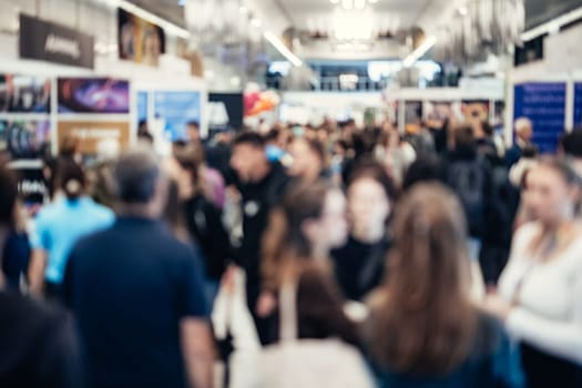 Abstract blurred people at exhibition hall of expo event trade show. Business convention show or job fair. Business concept background.