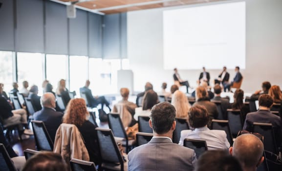 Interview and round table discussion at business convention and presentation. Audience at the conference hall. Business and entrepreneurship symposium.