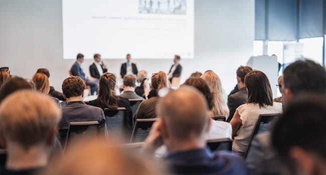 Interview and round table discussion at business convention and presentation. Audience at the conference hall. Business and entrepreneurship symposium.