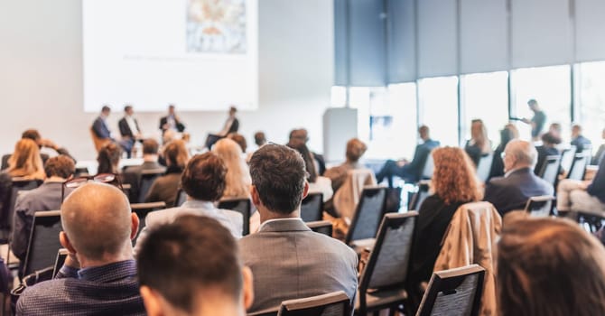 Interview and round table discussion at business convention and presentation. Audience at the conference hall. Business and entrepreneurship symposium.