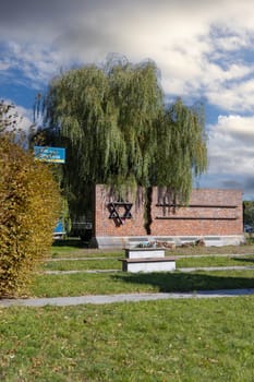 Czestochowa, Poland - October 18, 2024: Monument to Jews of Czestochowa, commemorates 40,000 Jews murdered in the Treblinka death camp. Star of David made of railway rails, crack in red brick wall