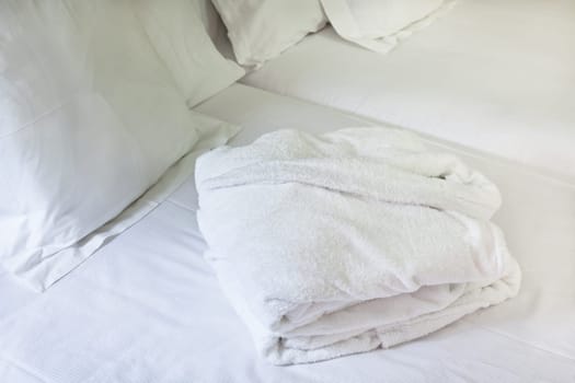 Night scene in hotel room: prepared fresh bed and bathrobe