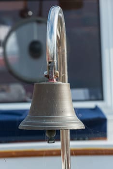 Brass ship bell on a classic sailboat. Close Up