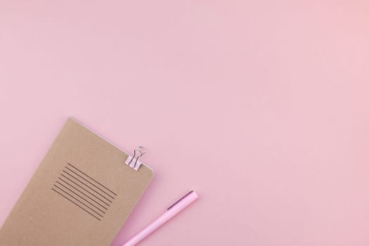 Top view flat lay of woman workspace desk styled design office supplies with copy space on a millennial pink color paper background minimal style. Template for feminine blog social media