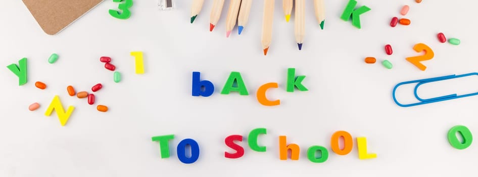 Long wide banner back to school concept with color school and office supplies on white table background with copy space, frame, template for text or design