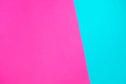 Blue and pink neon color paper geometric flat lay background texture