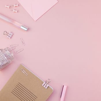 Top view flat lay of woman workspace desk styled design office supplies with copy space on a millennial pink color paper background minimal style. Square Template for feminine blog social media