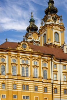 Melk, Austria - February 24, 2023: View of Melk Abbey with Collegiate Church towers on background of blue sky. It was was founded in 11th century, today's baroque abbey was built in 18th century