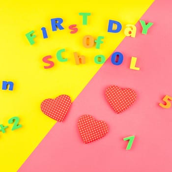 Square Creative flat lay back to school concept with welcome letters message on bright yellow and pink paper background with copy space, template for text or design