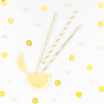 Square flatlay overhead top view citrus lemon slices and candies white table background with copyspace. Hot summer refreshment lemonade concept. Beverage ingredients arranged with straws