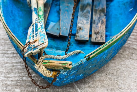 Old blue wooden shabby fishing boat detail. Shot with a selective focus