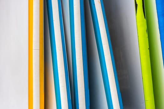 Set of different color surf boards in a stack. France