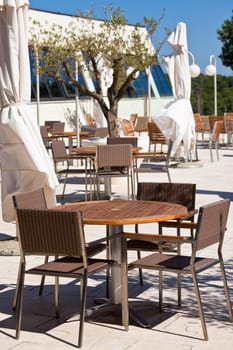 Summer outdoor cafe is empty in a hot midday