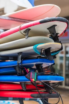 set of different color surf boards in a stack. France