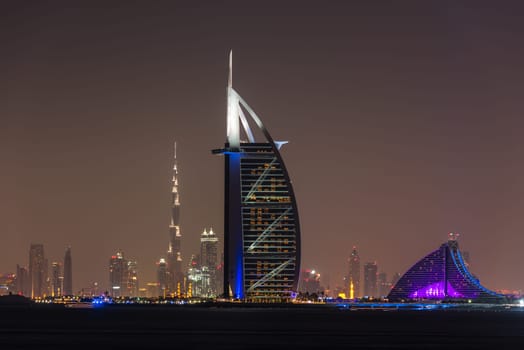 UAE, DUBAI - DECEMBER 26: Night cityscape of Dubai city with Burj Al Arab Jumeirah building on the front, United Arab Emirates on December 26, 2014