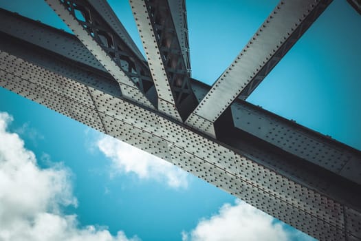 Bridge frame closeup on blue sky background. Horizontal toned image