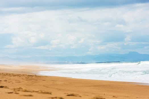 Long Sand Atlantic Beach with ocean waves. The Gironde Department, France. Shot with a selective focus