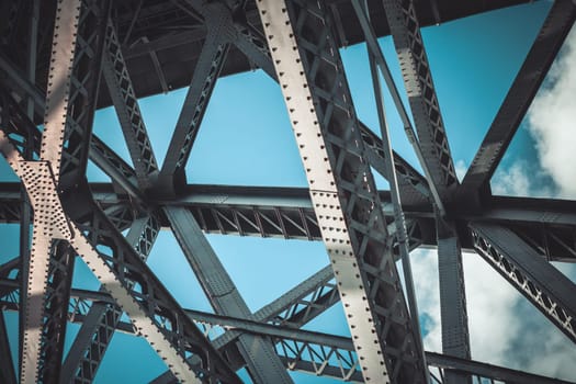 Bridge frame closeup on blue sky background. Horizontal toned image
