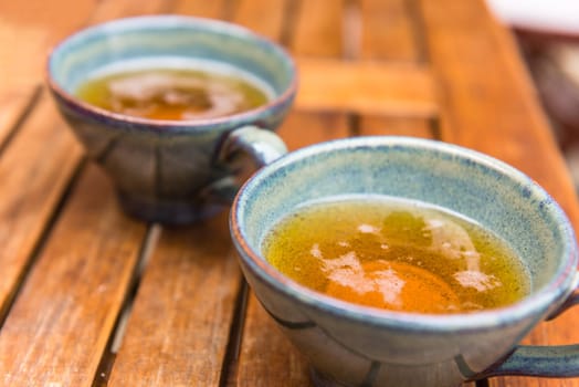 Norman apple cider in a typical ceramic cups. Shot with a selective focus
