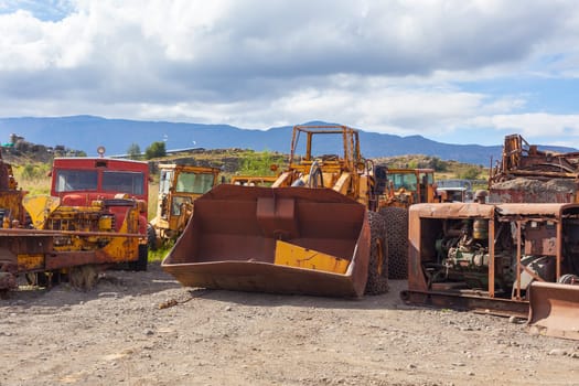 Old rusty and weathered bulldozers. Outdoors horizontal shot