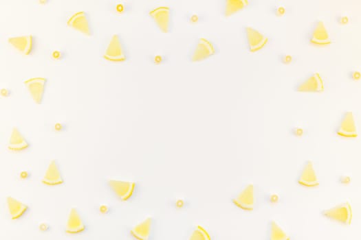 Creative flatlay overhead top view citrus lemon slices pattern frame white table background with copyspace. Hot summer refreshment lemonade concept. Beverage ingredients arranged