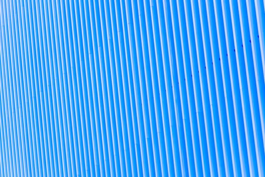 Detail of pattern striped metal facade for blue background