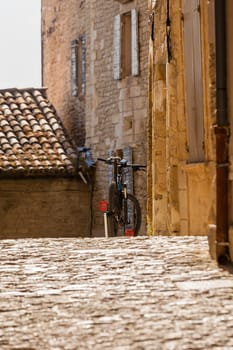 A bicycle on a street of an old town in the Southern Europe. Sunny day