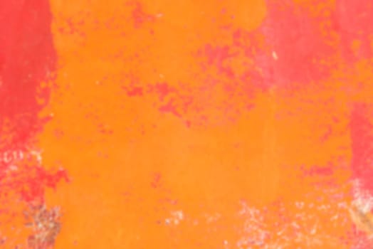Defocused Bright Orange painted surface background. Horizontal blur shot