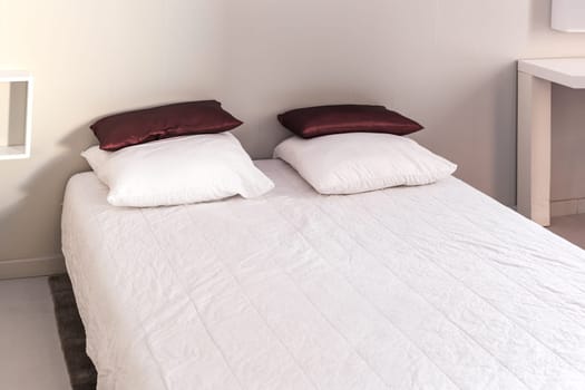 Prepared fresh bed, scene in apartments room. Horizontal shot