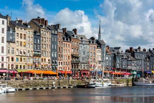 FRANCE, HONFLEUR - MAY 30: Honfleur harbour in Normandy, France. Color houses and their reflection in water on May 30, 2015