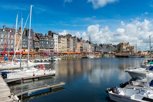FRANCE, HONFLEUR - MAY 30: Honfleur harbour in Normandy, France. Color houses and their reflection in water on May 30, 2015