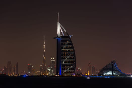 UAE, DUBAI - DECEMBER 26: Night cityscape of Dubai city with Burj Al Arab Jumeirah building on the front, United Arab Emirates on December 26, 2014