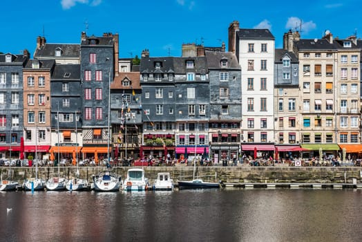 FRANCE, HONFLEUR - MAY 30: Honfleur harbour in Normandy, France. Color houses and their reflection in water on May 30, 2015