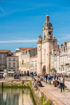 FRANCE, LA ROCHELLE - SEPTEMBER 21, 2015: View of people on the promenade in the old port of La Rochelle France