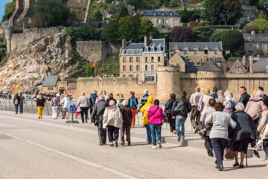 FRANCE, MONT SAINT MICHEL - SEPTEMBER 26: Old people visiting Mont Saint Michel monastery, Brittany, France on September 26, 2015