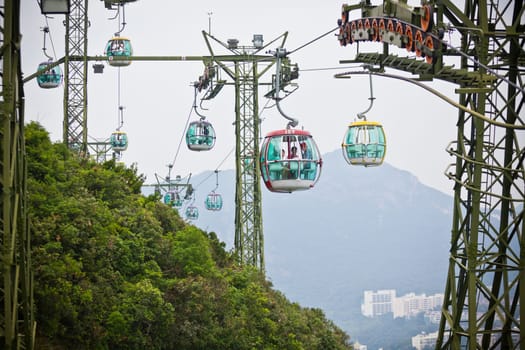 HONG KONG, HONG KONG - OCTOBER 01: cable cars over tropical trees in Hong Kong on October 01, 2012