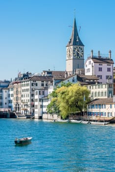 SWITZERLAND, ZURICH - AUGUST 22: view of historic Zurich city center with famous St. Peter and Fraumunster churches, Limmat river and Zurich lake on August 22, 2015