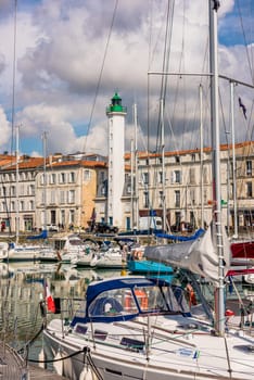 FRANCE, LA ROCHELLE - SEPTEMBER 21, 2015: View of yachts and a beautiful lighthouse in the old port of La Rochelle France