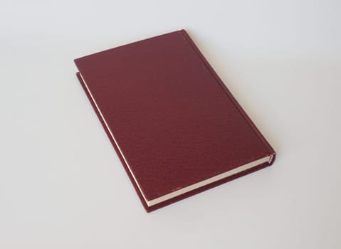 hardback book with leatherette cover over grey