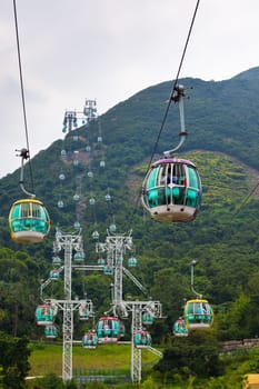 HONG KONG, HONG KONG - OCTOBER 01: cable cars over tropical trees in Hong Kong on October 01, 2012