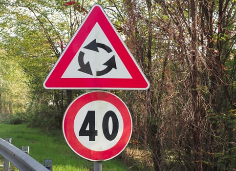 Warning signs, roundabout and speed limit traffic sign