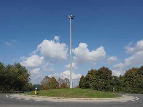 roundabout rotary traffic circle with cloudscape background
