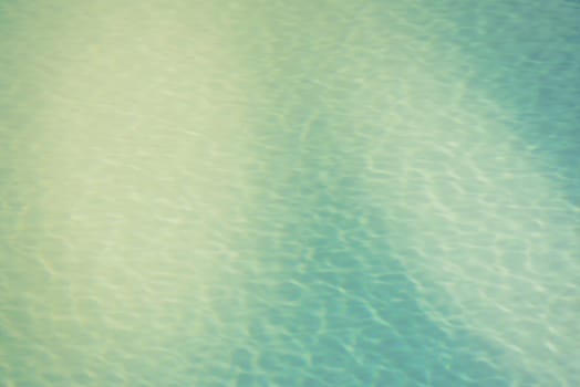 Clear transparent pool water background. Filtered blur shot