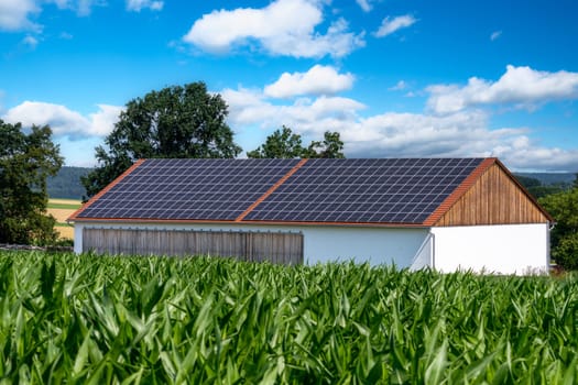 Green energy with solar collectors on the roof of an agricultural building