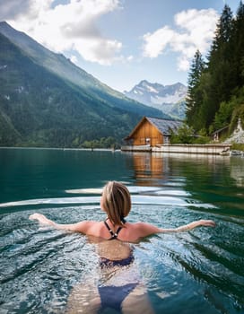 pretty young swimming woman in mountain lake, AI generated image