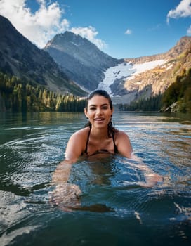 pretty young swimming woman in mountain lake, AI generated image