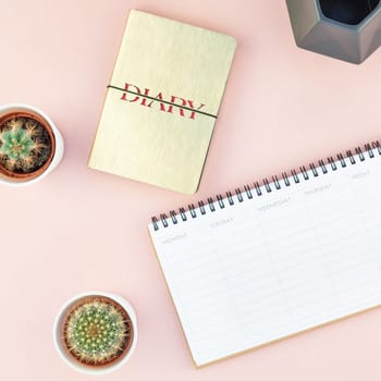 Top view flat lay workspace desk styled design office supplies cactuses succulents with copy space millennial pink color paper background minimal style. Square Template for feminine blog social media