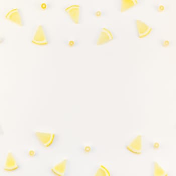 Square flatlay overhead top view citrus lemon slices pattern frame white table background with copyspace. Hot summer refreshment lemonade concept. Beverage ingredients arranged