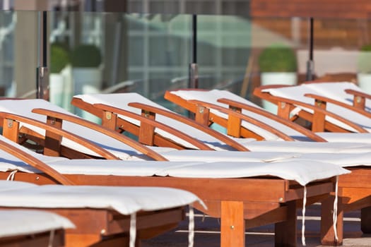 Hotel Wooden Poolside Chairs. Horizontal shot
