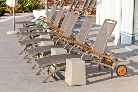 Hotel Wooden Poolside Chairs. Horizontal shot
